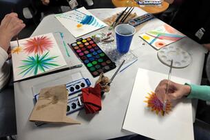 Students practice mindfulness techniques while painting with watercolors