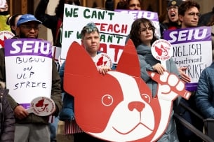 A photograph of people demonstrating as part of the Boston University graduate student worker strike, holding signs saying things such as "SEIU BUGWU on ULP strike."