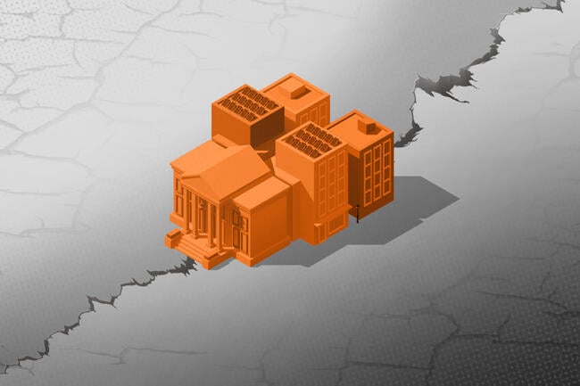 A group of school buildings sitting on a crack that extends across the frame.