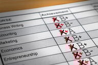 A report card with modified grades that have all been lowered. 