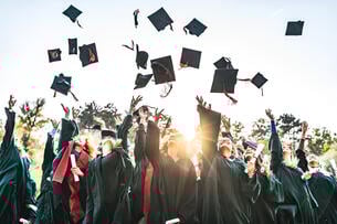 Graduates tossing their caps in the air