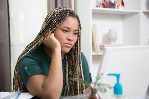Young woman looks at laptop frustrated