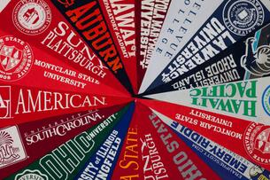 A collection of pennants for 18 different universities arranged pleasingly into a wheel-like design.