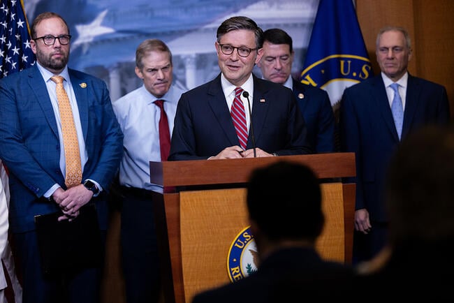 Mike Johnson stands at a podium flanked by other House lawmakers