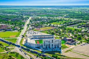 Aerial shot of San Marcos with residential homes, storefronts and the Texas State University campus.