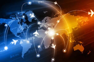 A dark world map lit up by bright icons of flights and jet paths, signifying global travel and interconnectedness.