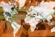 A map of the world with arrows flowing to the United States and money behind it. 