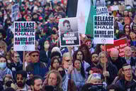 Protesters hold signs with Mahmoud Khalil's face on them to protest his arrest