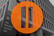 A pause symbol over the Department of Education building.