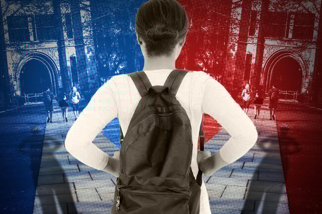 A student facing a forked path toward two different college campuses, one blue and the other red.