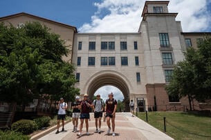Students walk on campus at Texas State University in San Marcos.