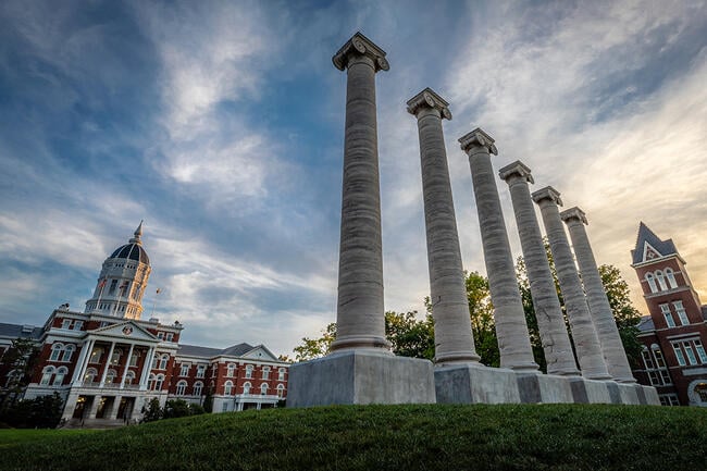 Architectural columns and Jesse Hall on the campus of University of Missouri. University of Missouri campus at sunset.