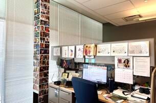 A look at an office at WPSU in central Pennsylvania. On the left side of the frame, a support pillar is covered in images of college students who worked at the station.