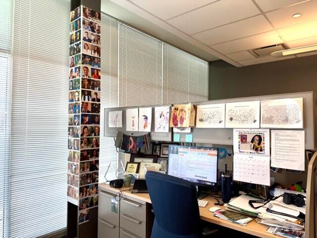 A look at an office at WPSU in central Pennsylvania. On the left side of the frame, a support pillar is covered in images of college students who worked at the station.